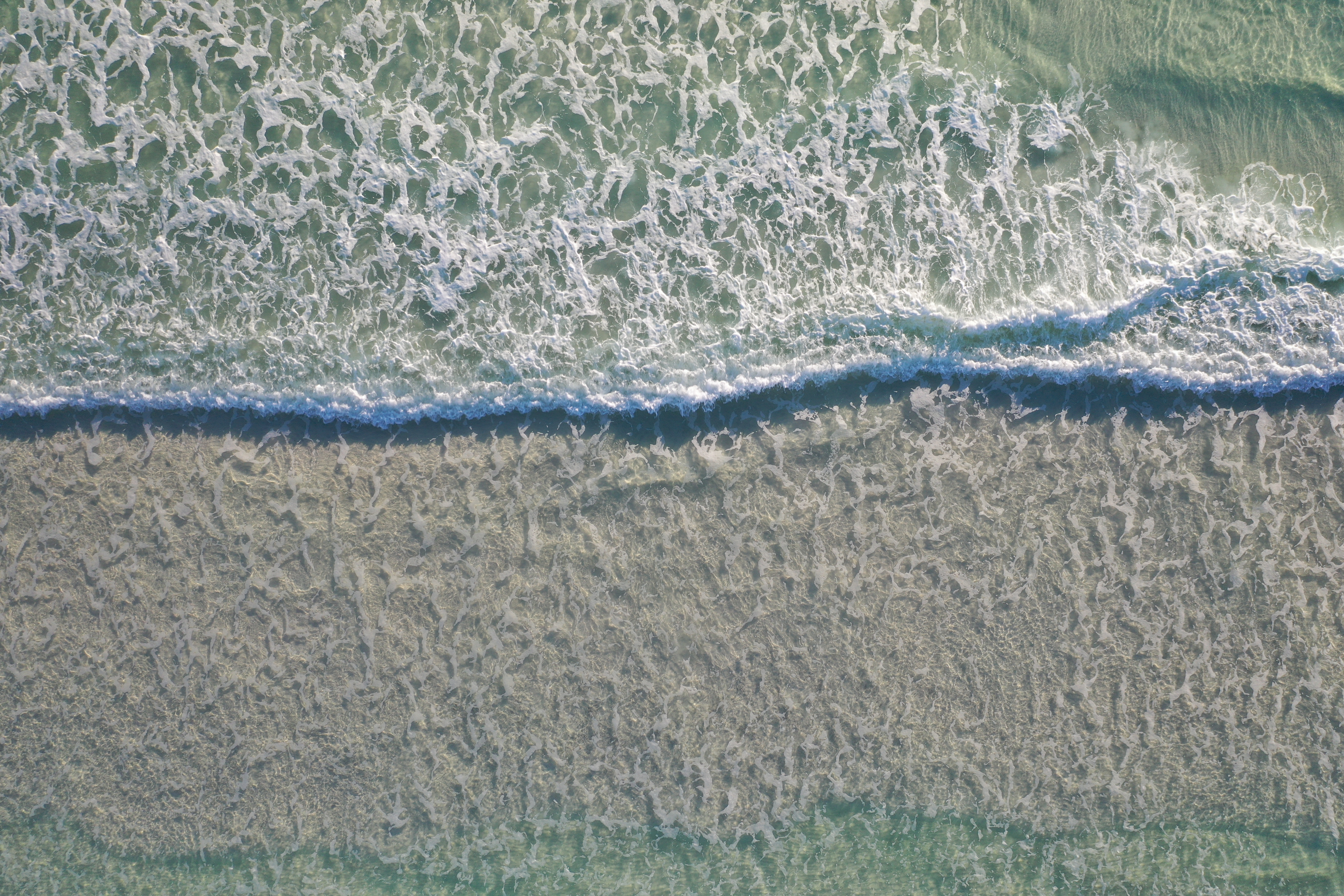 A gentle gulf wave rolling on shore in Santa Rosa Beach