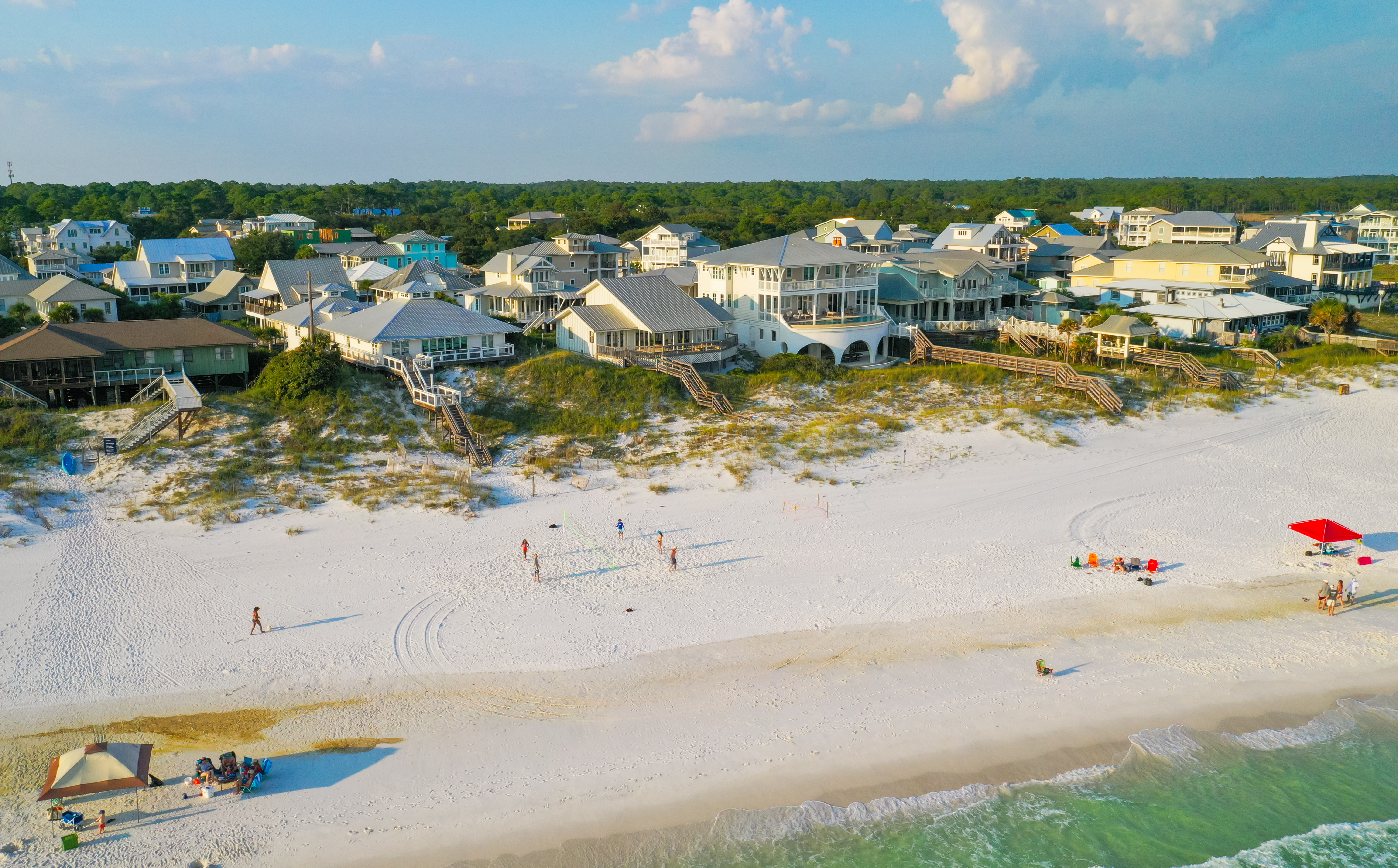A relaxing day on the beach at Grayton Beach with Gulf front homes in the background