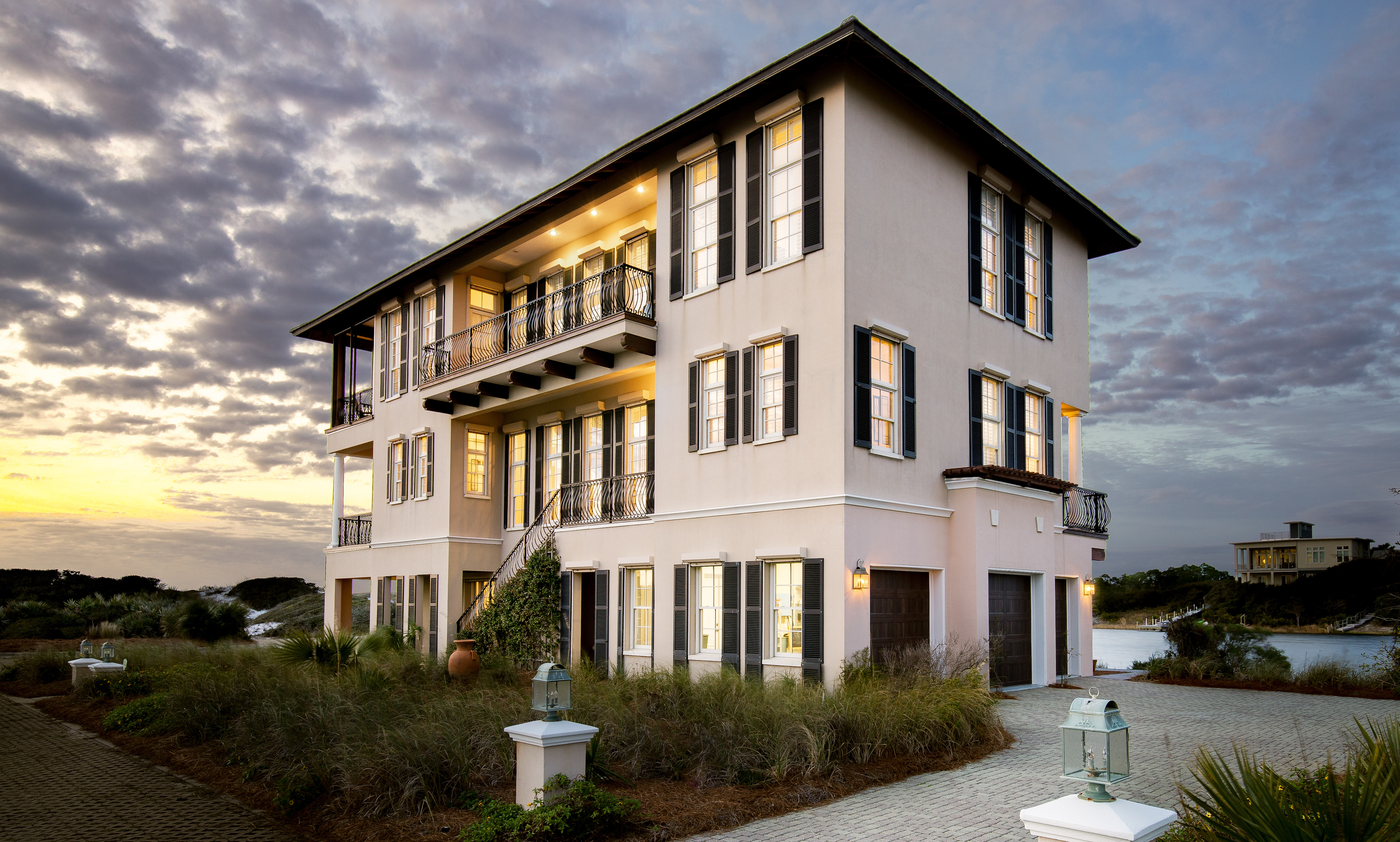 The exterior of a 3 story luxury home in Stallworth Preserve at dusk