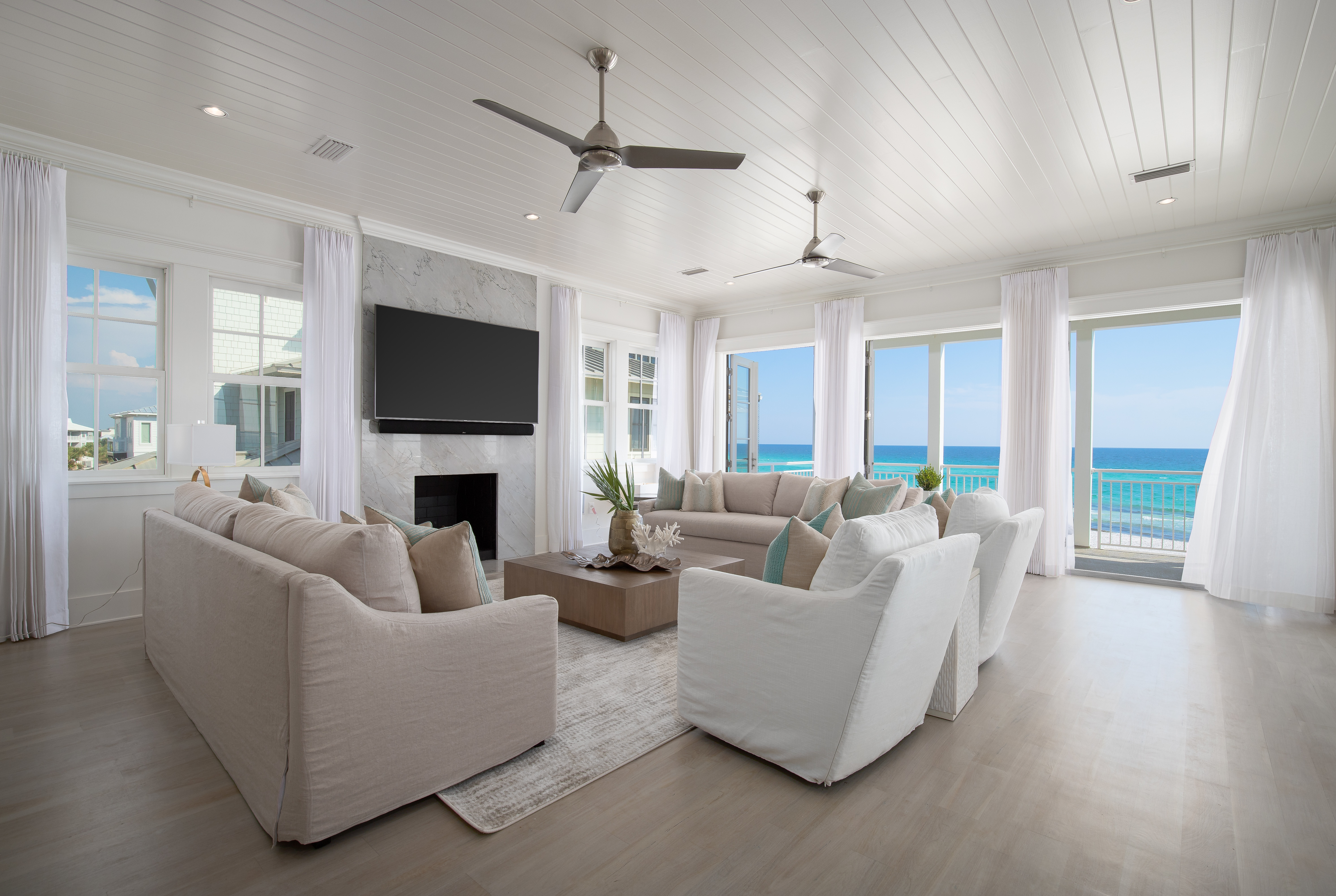 The living room of a gulf front home in Seagrove Beach with direct views of the water from every window