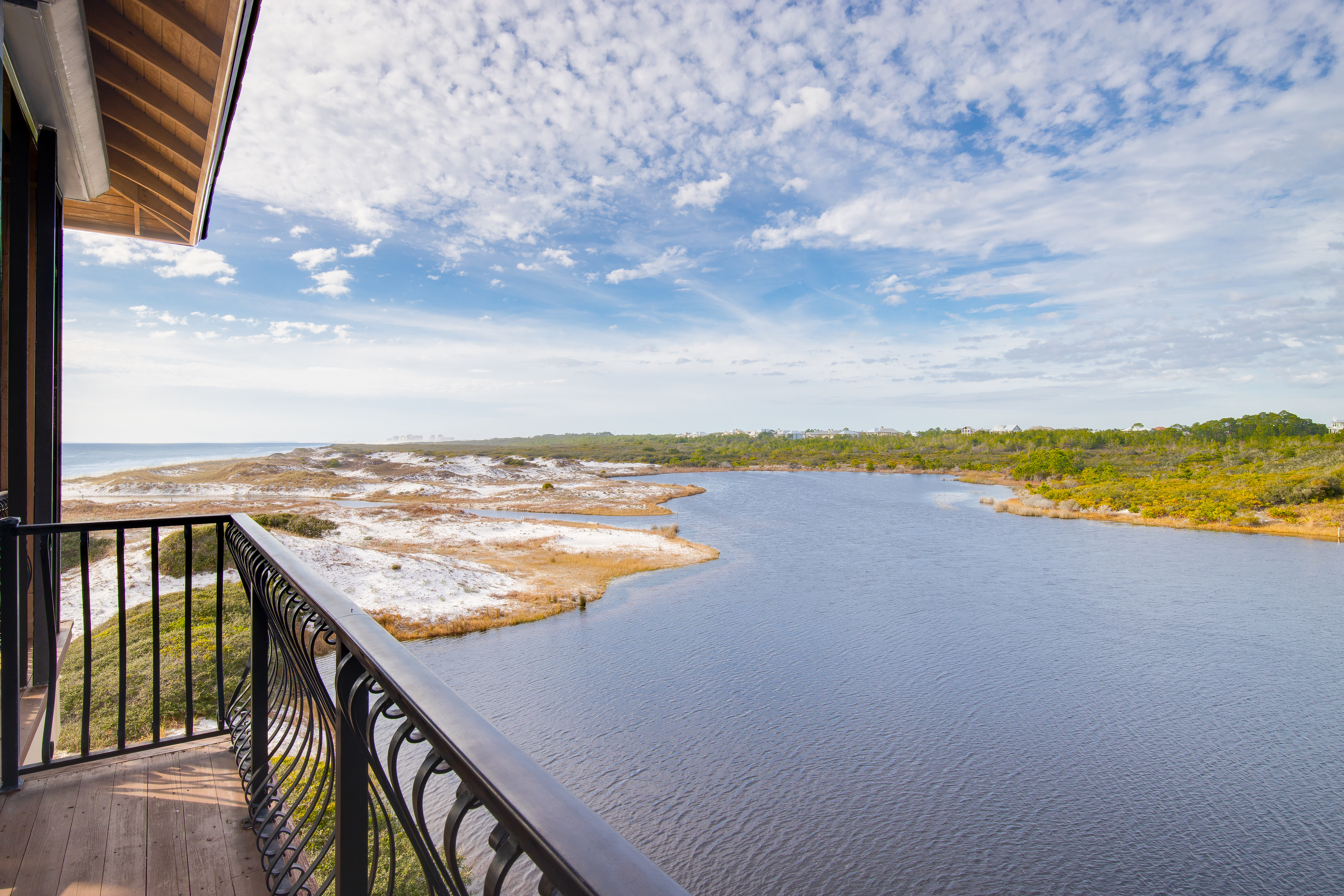 A view of Stallworth Lake from the balcony of a home framed by the beach