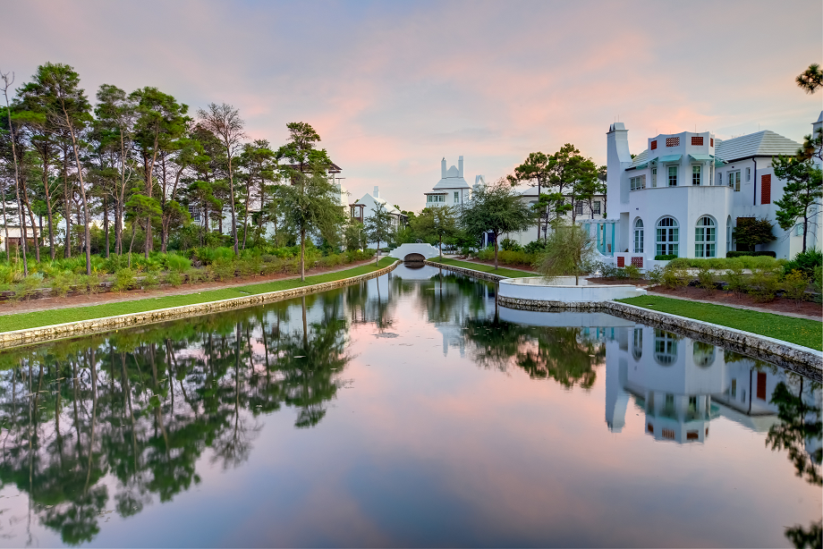 A view  of a lake among the homes of Alys Beach at sunset.