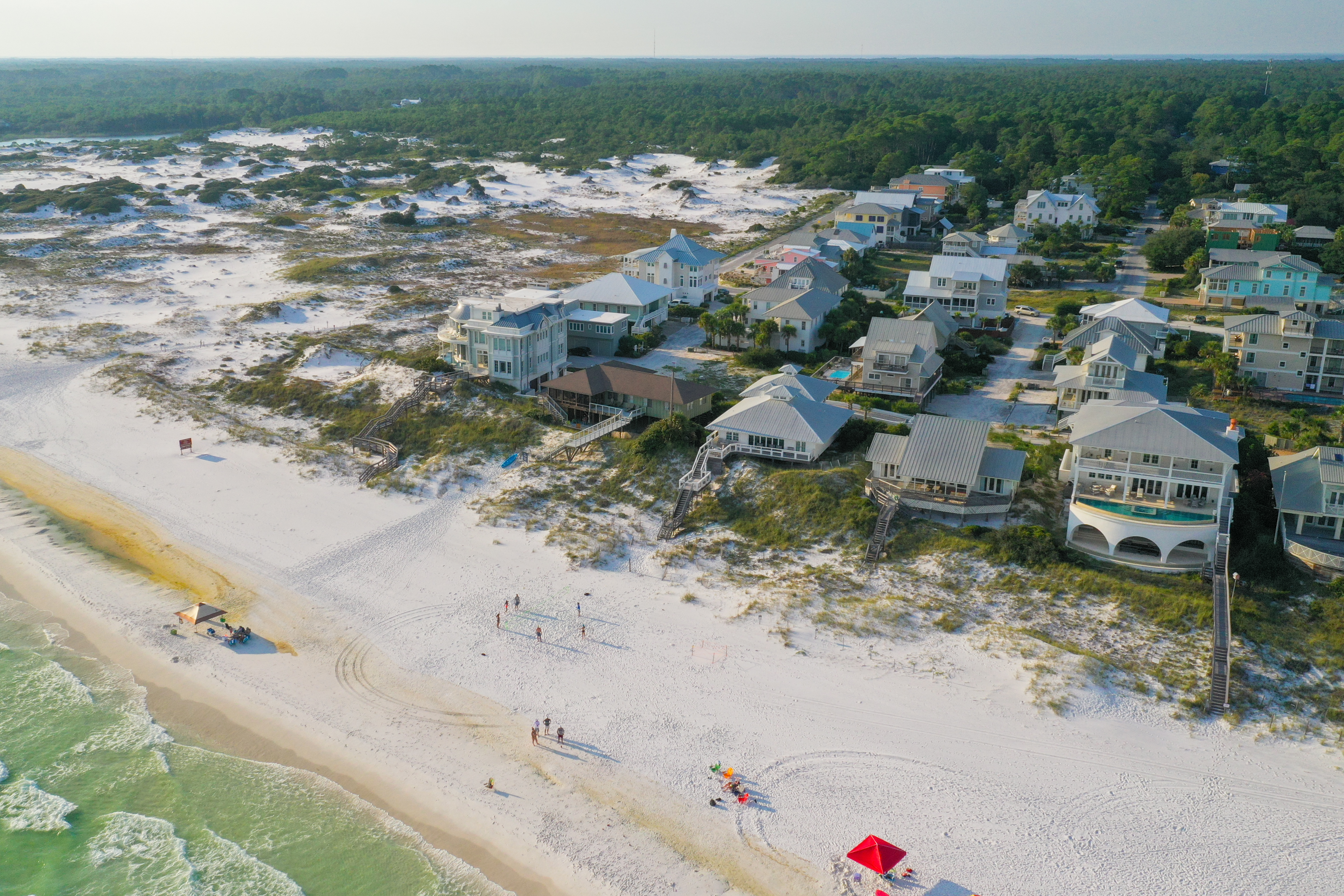 An aerial view of homes on the beach at Grayton Beach just before sunset