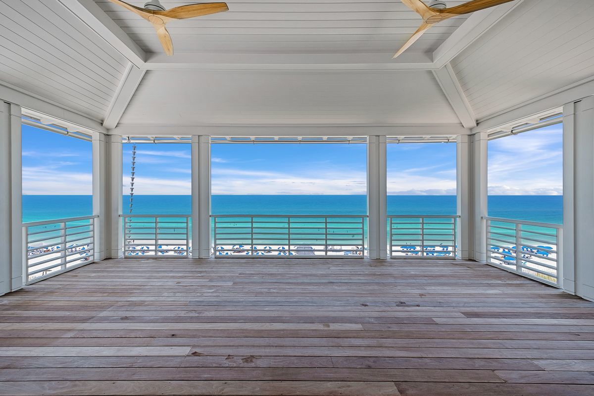 The view of brilliant blue gulf waters from the upper level balcony pool at a home in Seaside, FL