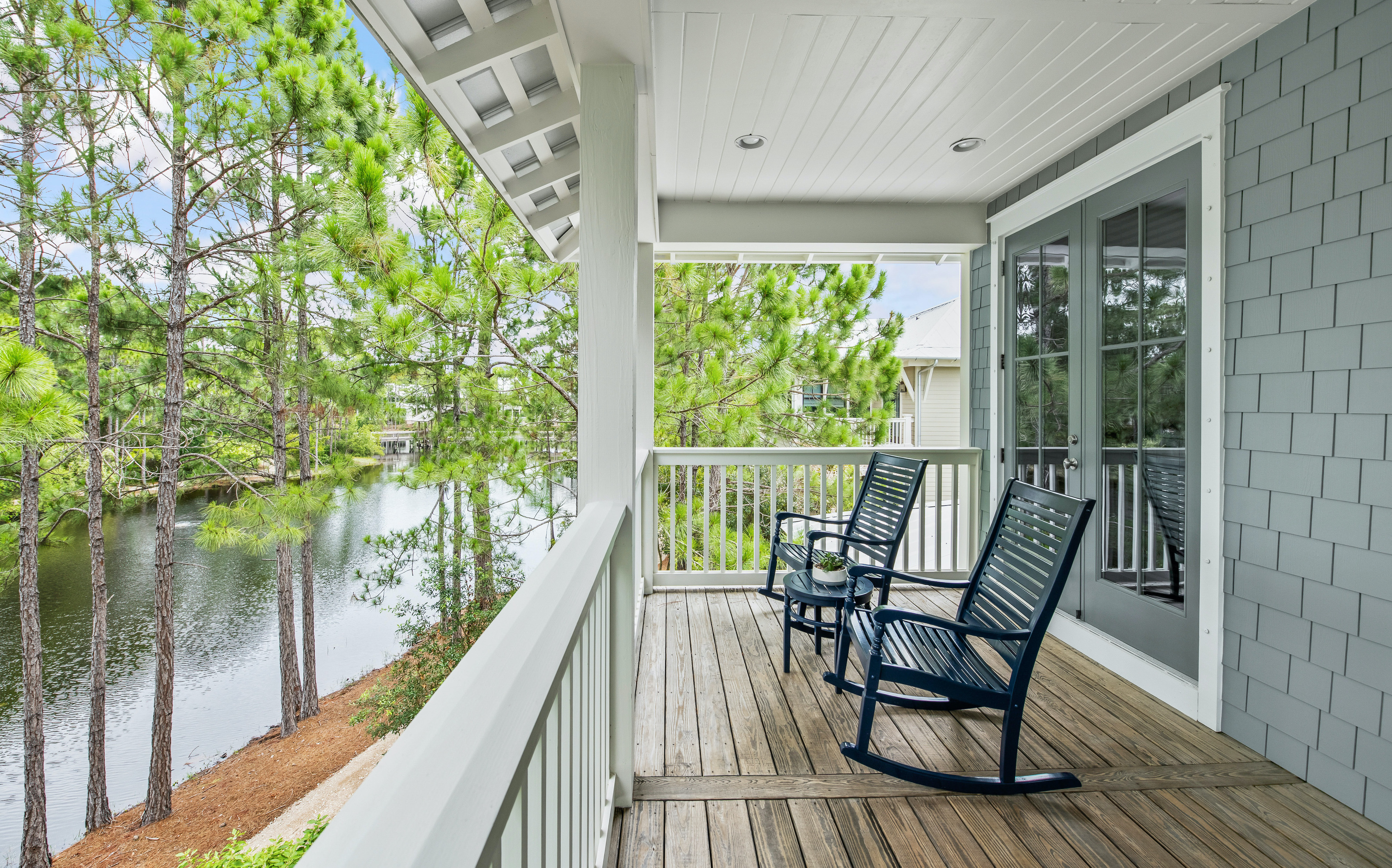 Rocking chairs on the porch overlooking the lake at a home in the Forest Lakes community